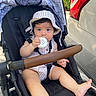 Mia joined the competition — help win amazing prizes! baby, stroller, hat, striped_clothing, child, outdoor, sun_hat, car, foot, hand, seat, black_seat, toy, straps, daylight, person, infant, cute, summer, park