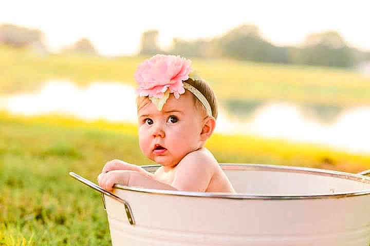 Evie joined the competition — help win amazing prizes! baby, baby_products, baby_toddler_clothing, bathing, child, fashion_accessory, flash_photography, fun, grass, hair_accessory, happy, headwear, leisure, people_in_nature, person, portrait_photography, recreation, sitting, sky, summer