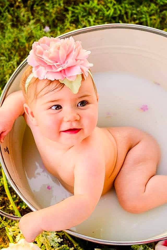 Evie Marie joined the competition — help win amazing prizes! baby, baby_toddler_clothing, bathing, cap, cheek, chin, face, flower, happy, head, headband, headgear, headpiece, headwear, lip, person, petal, pink, plant, skin