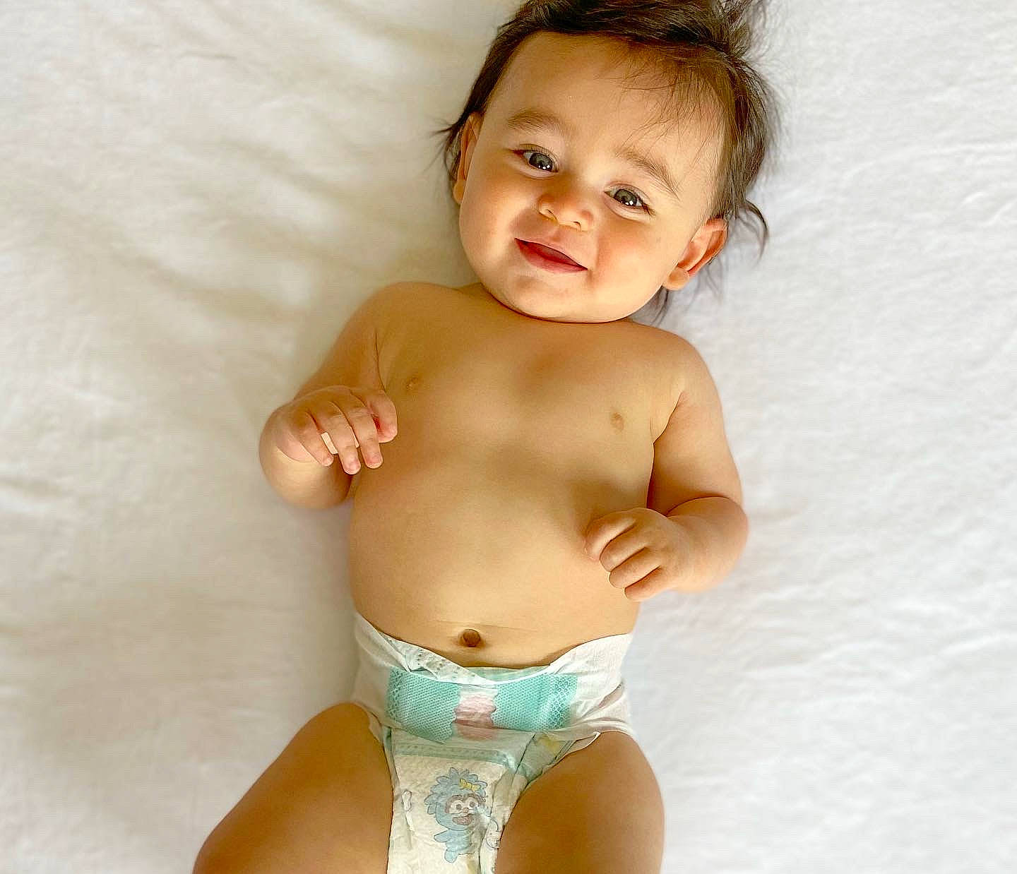 Joaquín is registered to the contest to win money with this photo: arm, baby, baby_toddler_clothing, cheek, chest, eye, finger, hand, happy, head, human_body, joint, joy, muscle, neck, person, skin, smile, stomach, swimwear