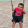barefoot, chains, child, curly_hair, daylight, fun, happy, joy, outdoor, park, person, play, playground, recreation, red_shirt, seat, shorts, smiling, swing, toddler