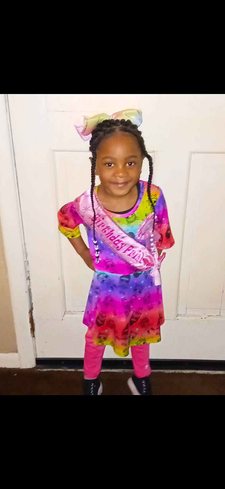 Z'Kailee is registered to the contest to win money with this photo: baby_toddler_clothing, beauty, child, dress, embellishment, event, face, fashion_accessory, fashion_design, fun, hair_tie, happy, joy, magenta, pattern, person, pink, purple, sleeve, smile
