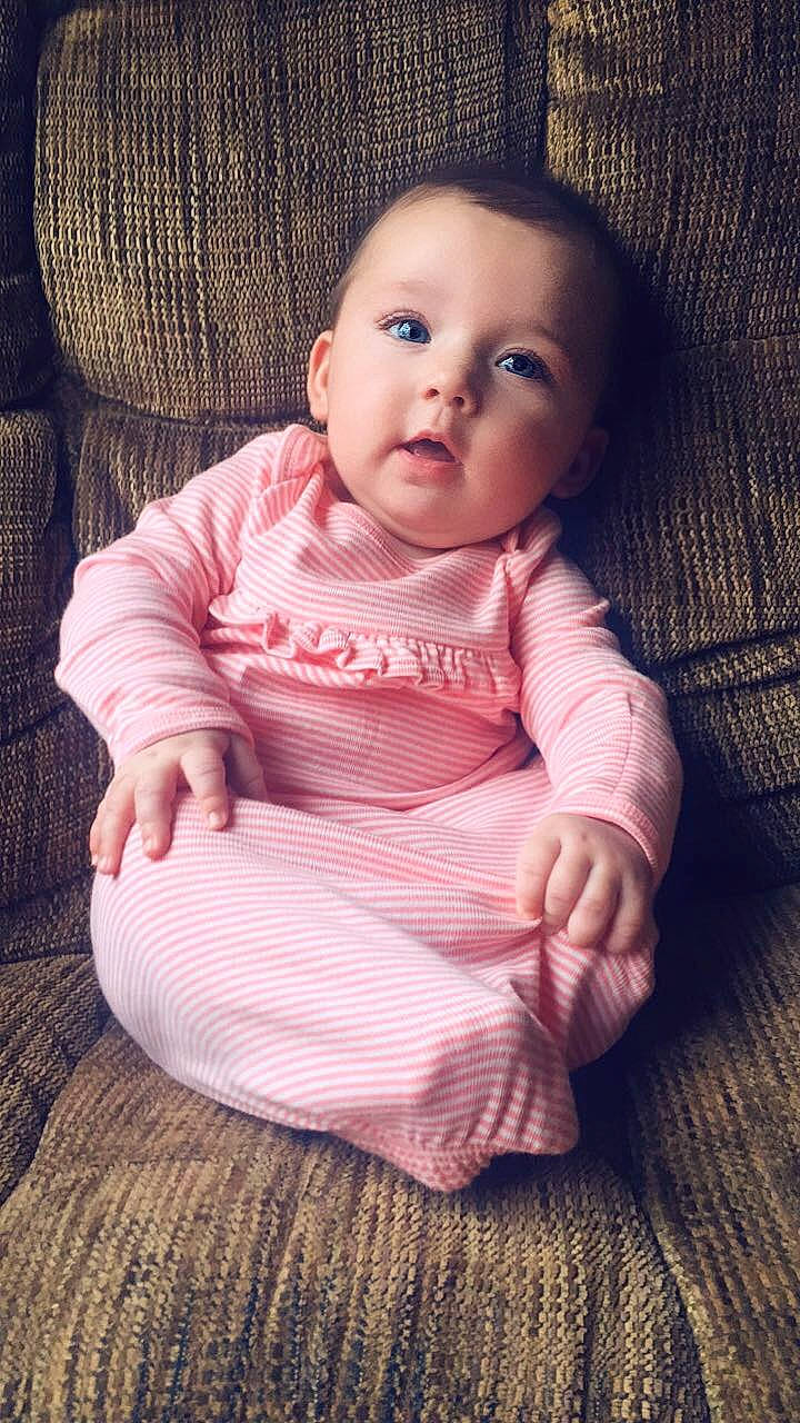 Avery is registered to the contest to win money with this photo: baby, beauty, cheek, child, chin, eye, face, head, lip, nose, person, photography, pink, portrait, portrait_photography, sitting, skin, sleeve, smile, toddler