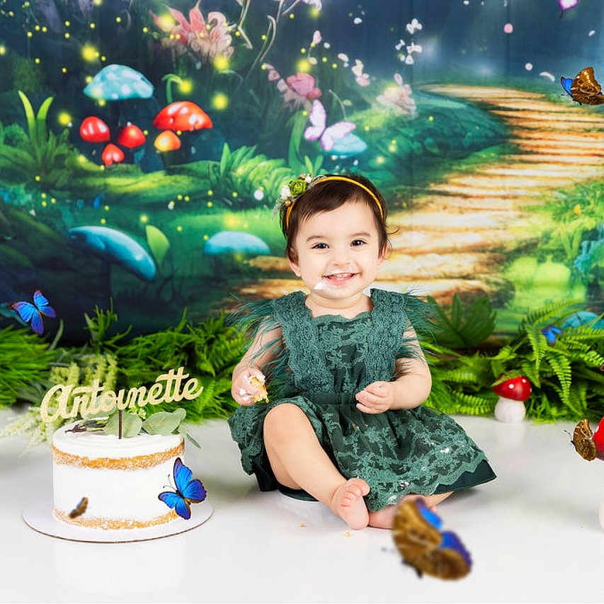 Antoinette joined the competition — help win amazing prizes! birthday, butterfly, cake, cake_smash, celebration, child, decorations, dress, fairytale, forest_backdrop, greenery, happy, headband, indoor, mushroom, party, photography, sitting, smile, toddler