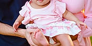 Emersyn is registered to the contest to win money with this photo: baby, child, infant, pink_dress, bow, headband, family, hands, holding, outdoor, sunlight, people, portrait, cute, smiling, dress, skin, person, closeup, happy