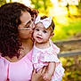 Emersyn is registered to the contest to win money with this photo: woman, baby, child, kiss, pink_dress, bow, glasses, curly_hair, outdoor, nature, sunlight, affection, portrait, love, family, holding, happy, smile, person, blurred_background