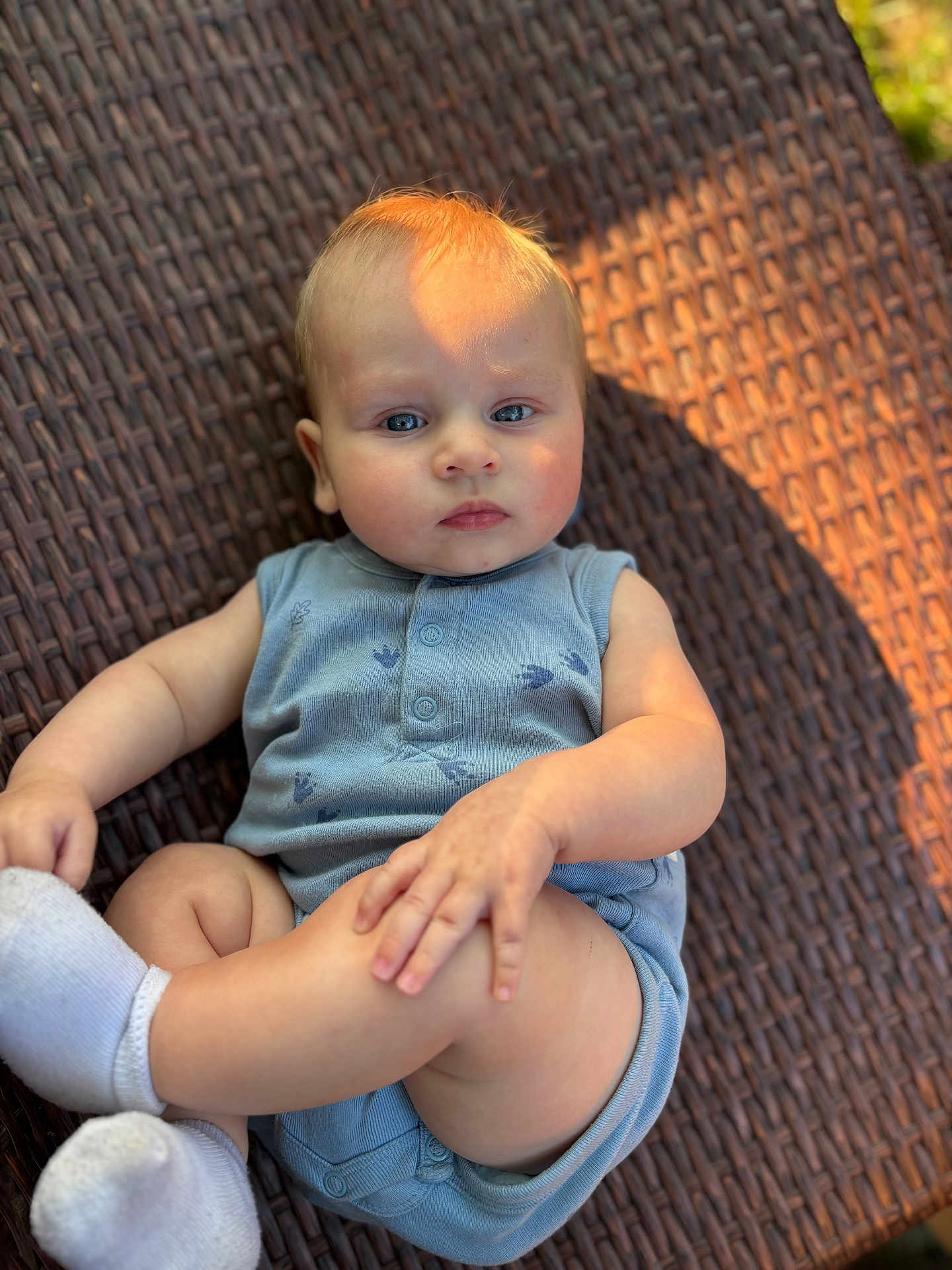 Bowen joined the competition — help win amazing prizes! baby, child, infant, blue_onesie, white_socks, woven_surface, sunlight, shadow, skin, face, hand, leg, foot, portrait, outdoor, serious_expression, human, cute, one_person, sitting