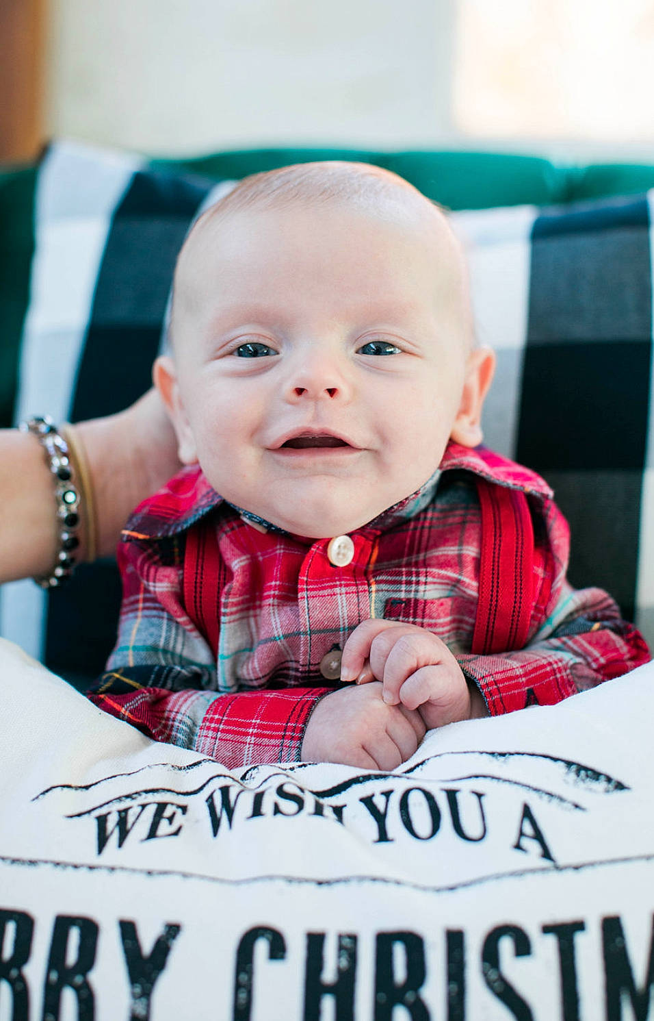 Cutter is registered to the contest to win money with this photo: baby, baby_toddler_clothing, cheek, child, design, event, facial_expression, font, fun, happy, pattern, person, photo_caption, plaid, sitting, sleeve, smile, t_shirt, tartan, toddler