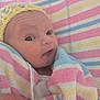 Skylah is registered to the contest to win money with this photo: baby, newborn, infant, towel, striped_towel, knitted_hat, yellow_hat, hand, wrapped, close_up, face, curious_expression, soft_colors, pastel_colors, skin, person, portrait, indoors, cozy, child
