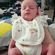 Skylah joined the competition — help win amazing prizes! baby, infant, bib, sleepy, person, hand, clothing, indoor, bedroom, blanket, furniture, soft, newborn, cute, skin, legs, comfort, resting, child, family