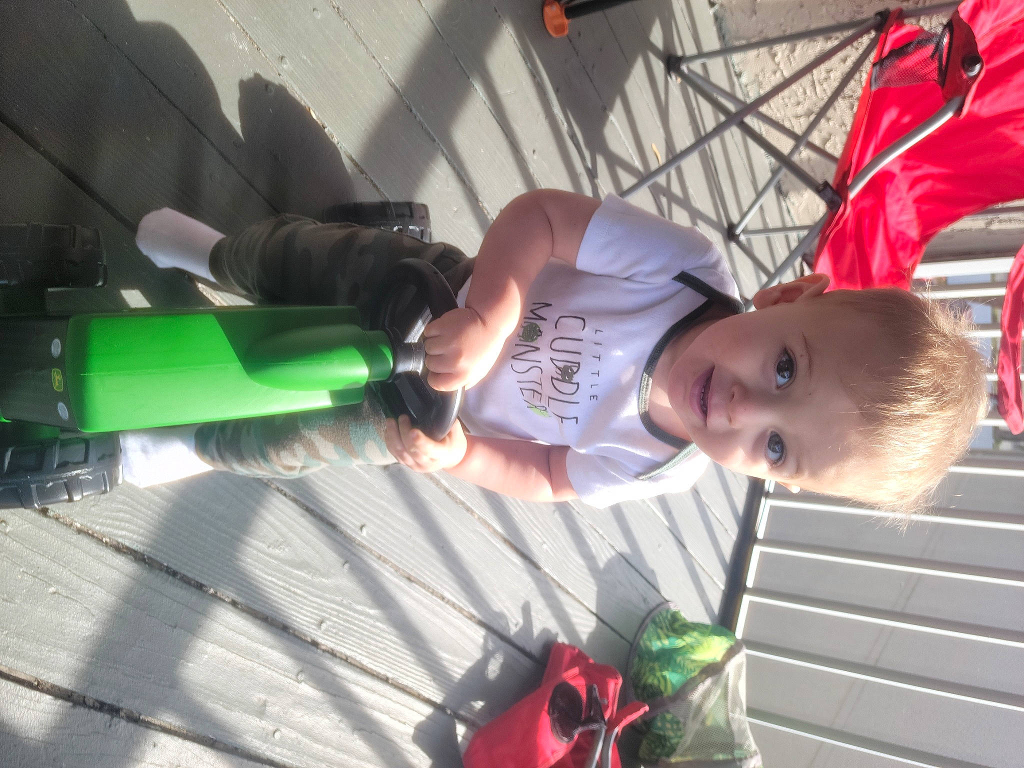 C.j. is registered to the contest to win money with this photo: automotive_lighting, child, elbow, fun, leisure, person, plant, recreation, smile, t_shirt, toddler, windshield