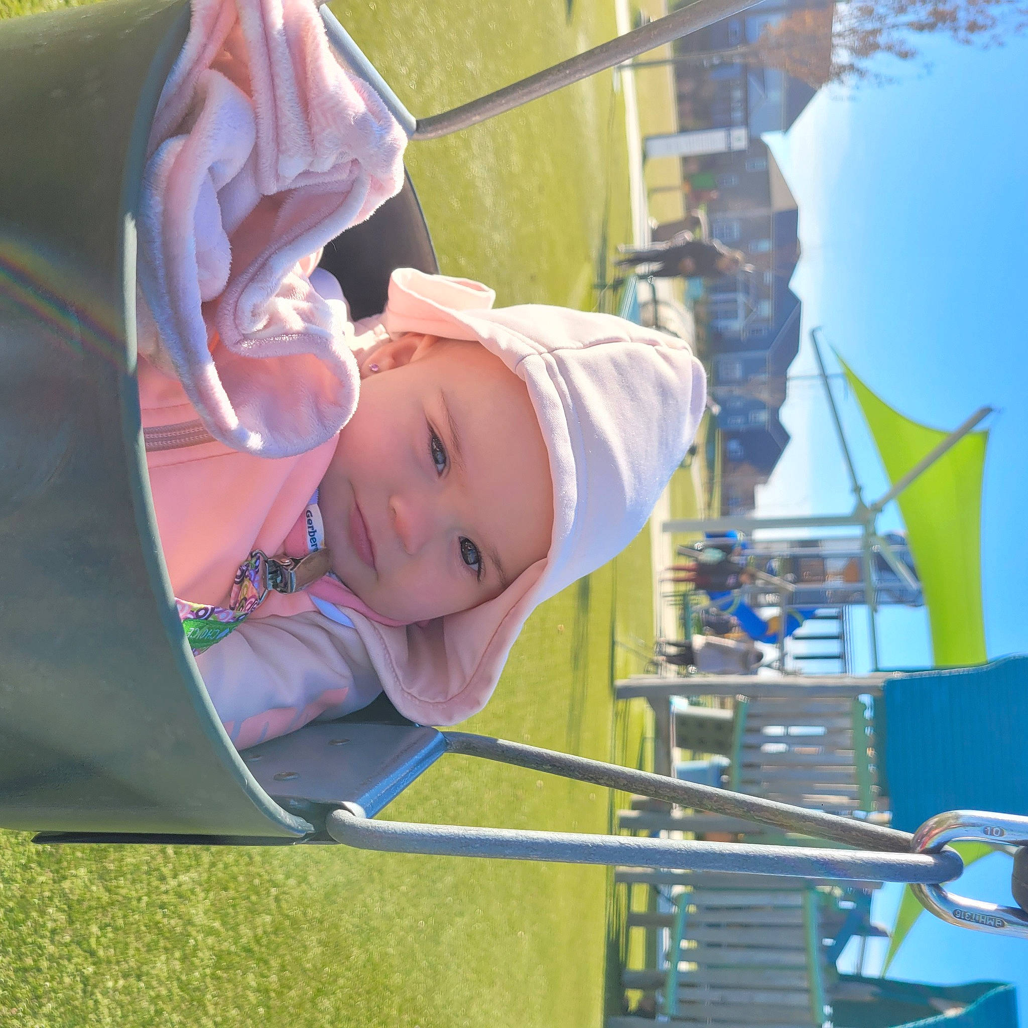 Kinsley joined the competition — help win amazing prizes! baby, baby_toddler_clothing, child, fun, grass, happy, hat, headwear, house, leisure, outdoor_play_equipment, person, playground, public_space, recreation, sky, smile, sun_hat, toddler, tree