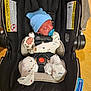 Crew is registered to the contest to win money with this photo: baby, newborn, car_seat, blue_hat, pacifier, sleeping, infant, onesie, safety_harness, black_car_seat, warning_label, wooden_floor, cute, indoors, child, small_hands, cozy, resting, toddler, protectplus