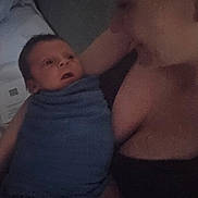 Crew is registered to the contest to win money with this photo: baby, infant, adult, person, blanket, blue_blanket, indoor, low_light, grainy, portrait, closeup, face, skin, expression, holding, cuddle, love, family, tender, quiet