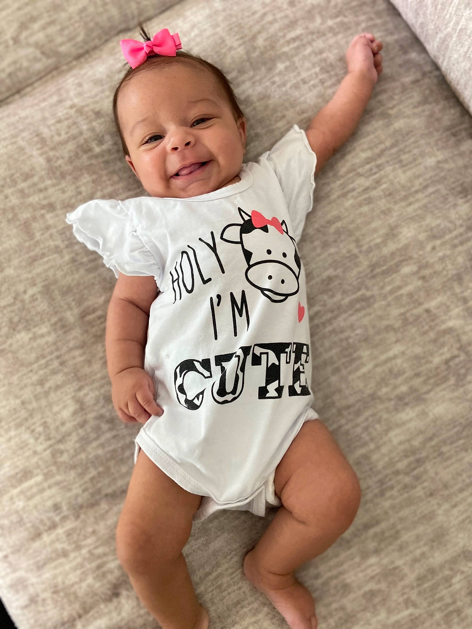 Giavanna is registered to the contest to win money with this photo: baby, baby_toddler_clothing, clothing, facial_expression, floor, flooring, gesture, happy, head, human_body, joy, organ, person, pink, skin, sleeve, smile, sportswear, t_shirt, toddler