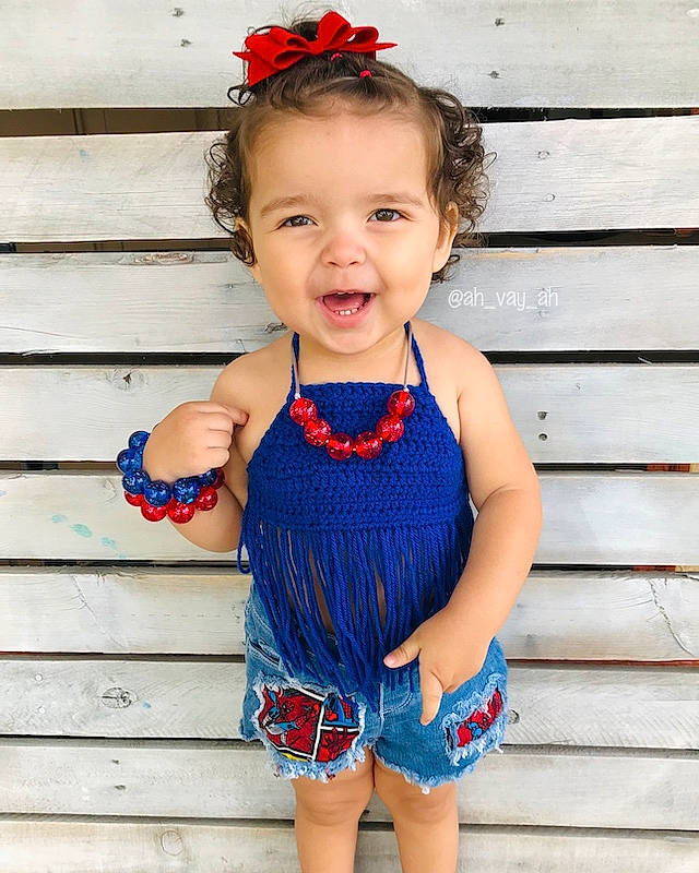 Avaya is registered to the contest to win money with this photo: baby, baby_bloomers, baby_products, baby_toddler_clothing, blue, child, child_model, clothing, costume, costume_accessory, dress, fashion_accessory, hair_accessory, headband, pattern, person, red, ruffle, textile, toddler