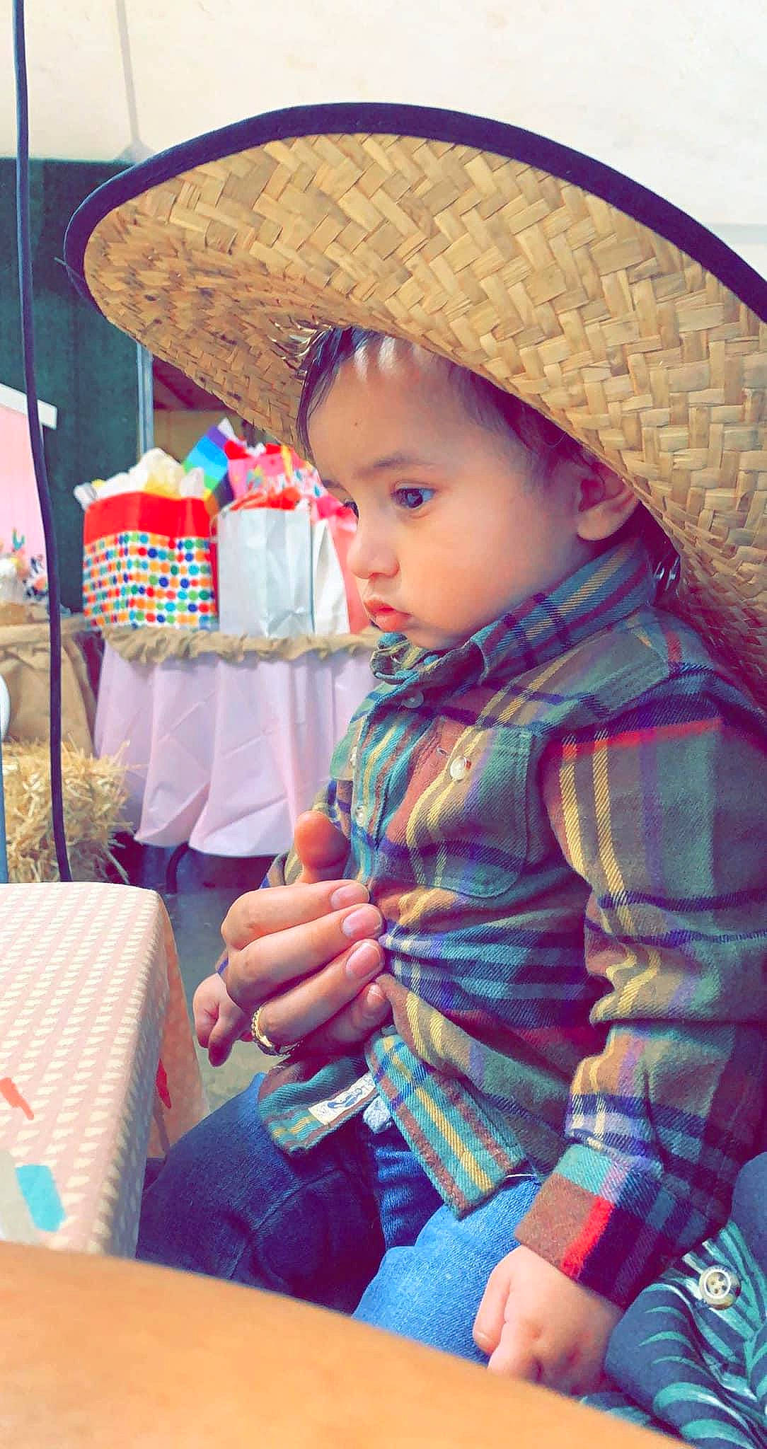 Joaquin is registered to the contest to win money with this photo: baby, baby_toddler_clothing, blue, cap, chair, child, face, fashion_accessory, fun, happy, hat, human, leisure, lip, person, plaid, sitting, skin, street_fashion, sun_hat