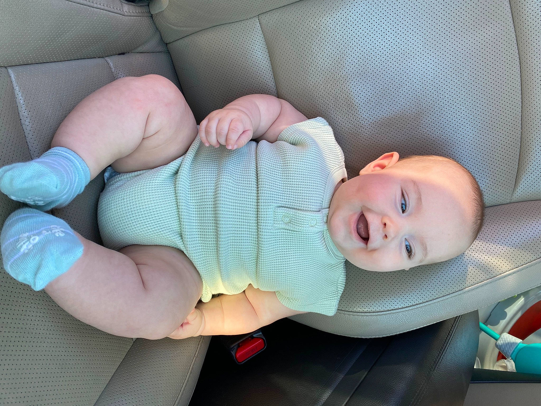 Lucca is registered to the contest to win money with this photo: arm, baby, baby_products, baby_toddler_clothing, child, comfort, elbow, finger, gesture, hand, human_body, human_leg, joy, mouth, nail, person, skin, smile, textile, thumb
