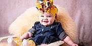 Emma joined the competition — help win amazing prizes! baby, infant, child, headband, floral_bow, denim_dress, wicker_chair, fluffy_throw, smile, portrait, cozy, studio_background, pink_background, rosy_cheeks, sitting, legs, arm, socks, closeup, photography