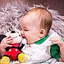 Emma is registered to the contest to win money with this photo: baby, infant, child, portrait, closeup, smiling, plush_toy, stuffed_animal, mickey_mouse, fur_blanket, cuddling, hand, dress, green_clothing, white_lace, soft_texture, indoors, cute, photography, watermark