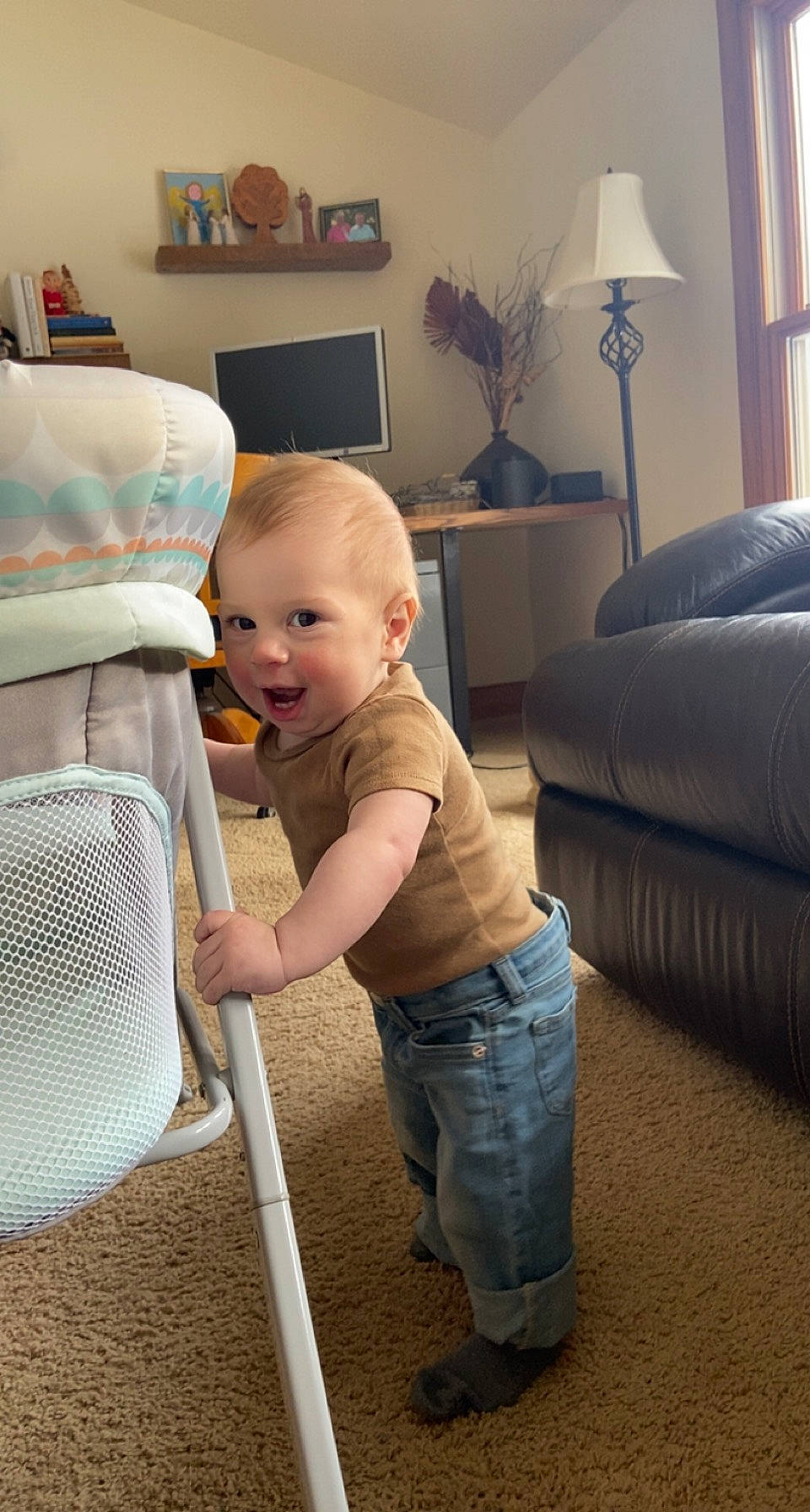 Maverick is registered to the contest to win money with this photo: baby, baby_toddler_clothing, child, comfort, couch, floor, flooring, hardwood, home_appliance, houseplant, lamp, living_room, person, picture_frame, room, sitting, studio_couch, t_shirt, television, toddler