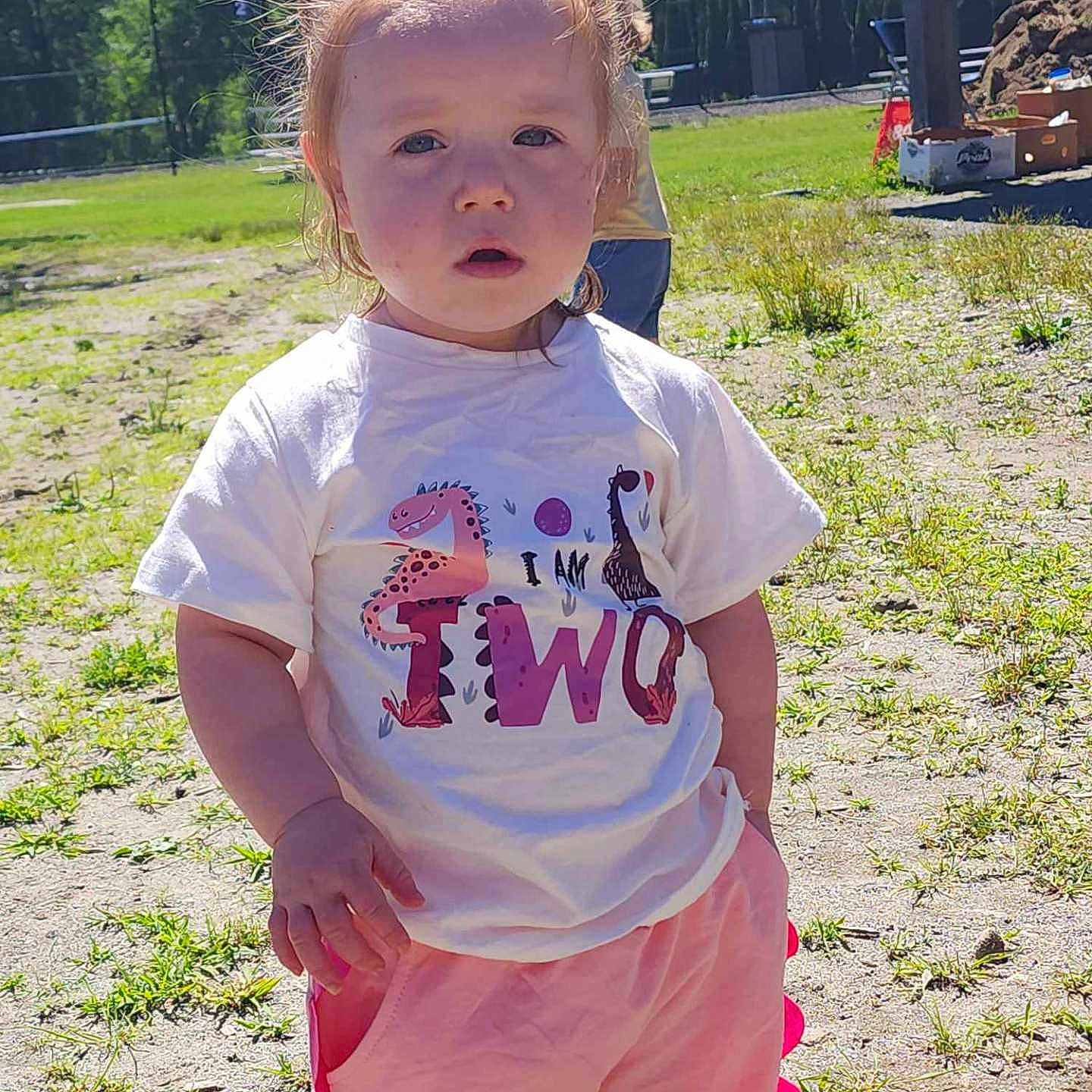 Paisley is registered to the contest to win money with this photo: backyard, child, clothing, face, female, girl, grass, hair, head, nature, outdoors, park, person, photography, plant, portrait, sleeve, standing, t_shirt, yard