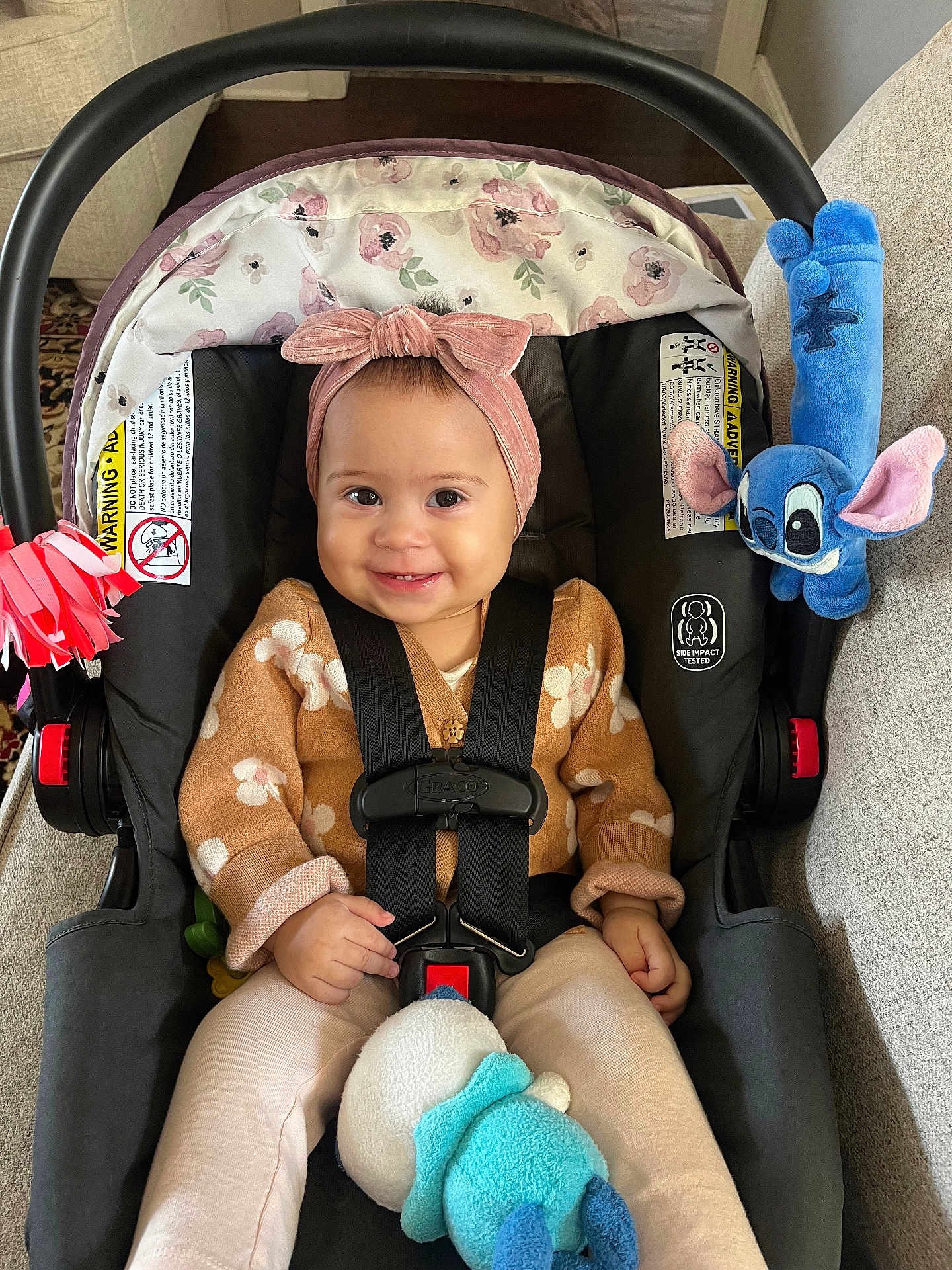 Isabella joined the competition — help win amazing prizes! baby, car_seat, headband, smile, toy, plush_toy, child, indoor, safety_harness, clothing, cute, infant, person, seat, fabric, accessory, happy, toddler, sitting, portrait