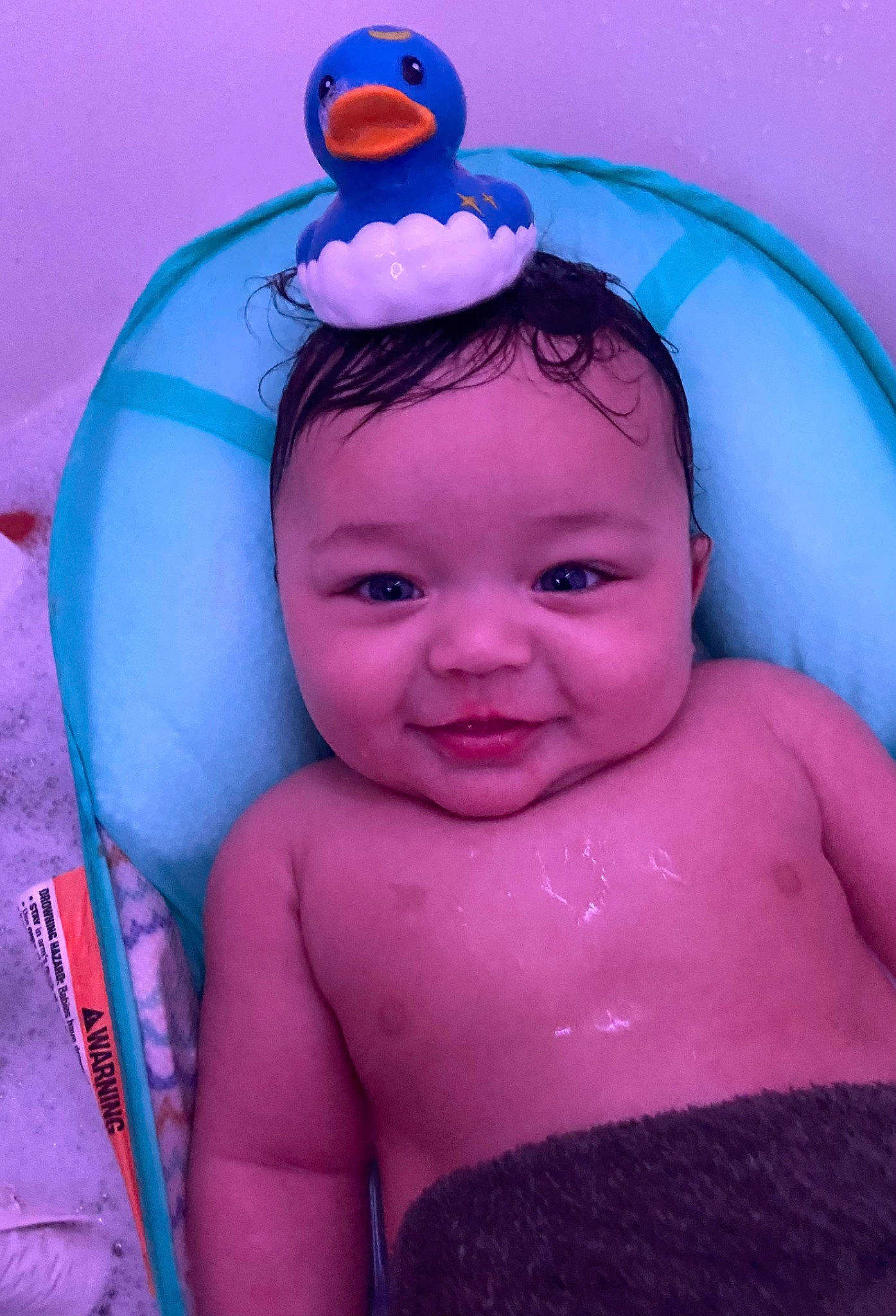 Josiah is registered to the contest to win money with this photo: azure, baby, cheek, chin, eye, eyebrow, facial_expression, hair, happy, head, headgear, headwear, human_body, iris, joy, neck, organ, person, pink, purple