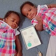 Naomie Et Naelle participe au concours pour gagner de l'argent avec cette photo : baby, infant, toddler, child, plaid_dress, pink, lying_down, blanket, pacifier, toy, card, milestone, cute, face, skin, hair, indoor, sleepy, resting, person