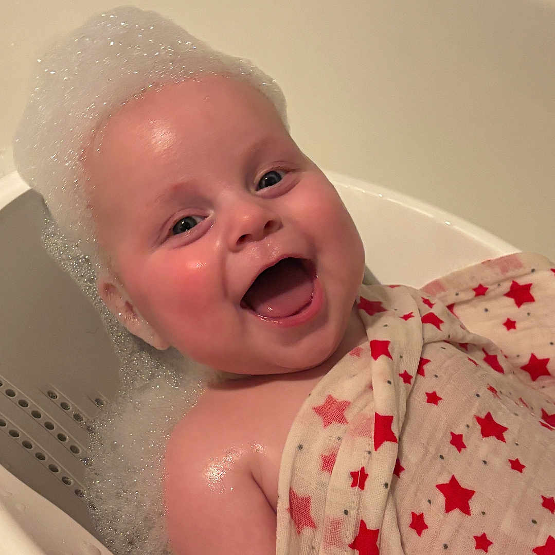 Paisley joined the competition — help win amazing prizes! baby, bathing, bathtub, bodypart, face, finger, hand, happy, head, mouth, newborn, person, photography, portrait, smile, tub