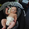 Jameson is registered to the contest to win money with this photo: baby, infant, diaper, plush_toy, bunny, baby_seat, cushion, indoor, floor, wooden_floor, cute, child, person, skin, legs, arms, head, smile, relaxing, comfort