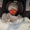 Jameson joined the competition — help win amazing prizes! newborn, baby, infant, car_seat, blanket, hat, pacifier, swaddle, dinosaur_pattern, child, sleepy, indoors, soft_texture, clothing, seatbelt, person, cute, comfort, resting, portrait