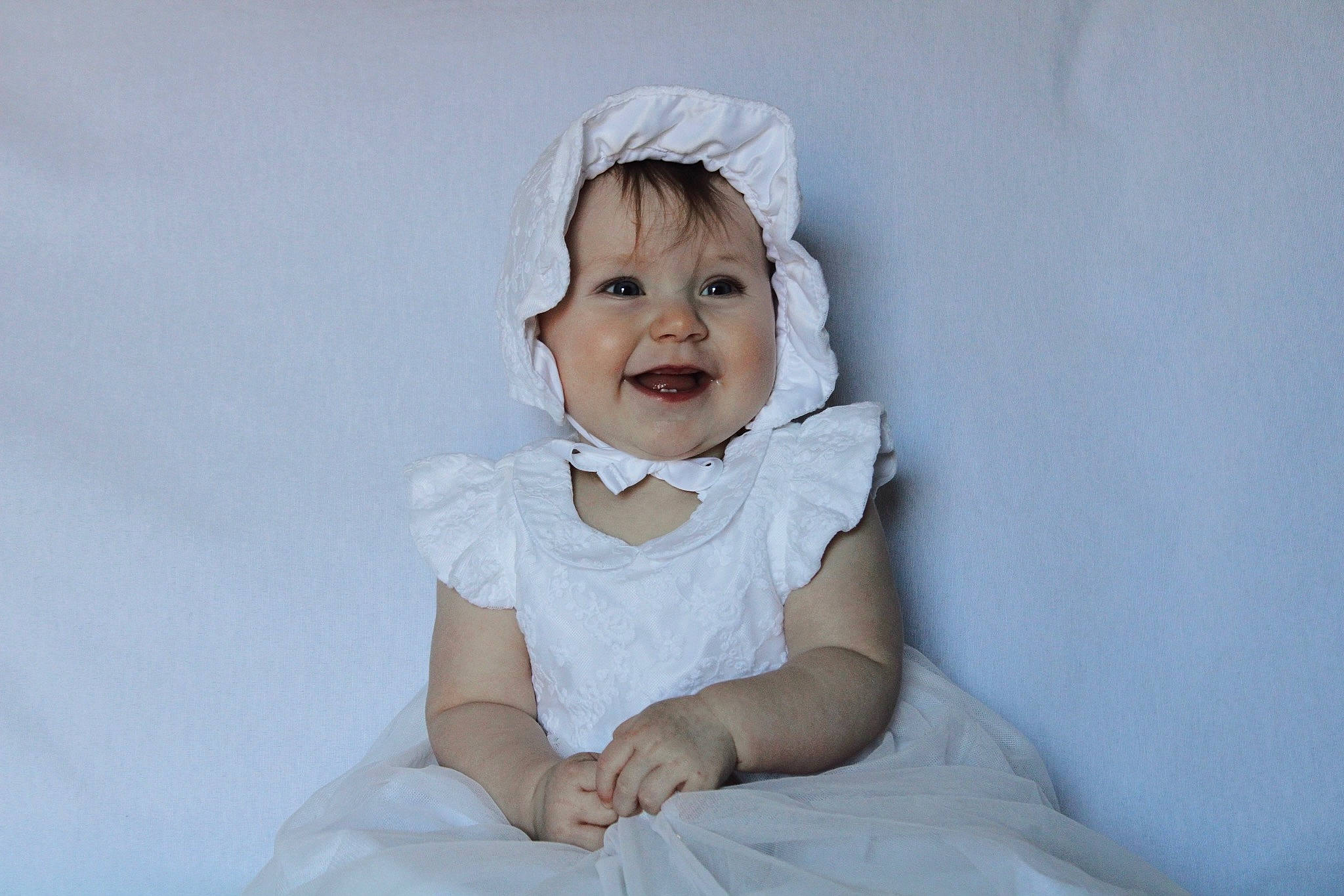 Amara is registered to the contest to win money with this photo: baby, baby_toddler_clothing, bridal_accessory, child, comfort, dress, face, fashion_accessory, flash_photography, fun, gesture, happy, headgear, iris, joy, person, portrait_photography, sitting, skin, sleeve
