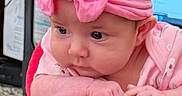 Raylynn is registered to the contest to win money with this photo: adorable, baby, child, closeup, clothing, curious, cute, expression, face, hands, headband, indoor, infant, person, pink_bow, portrait, resting, small_hands, soft_lighting, young