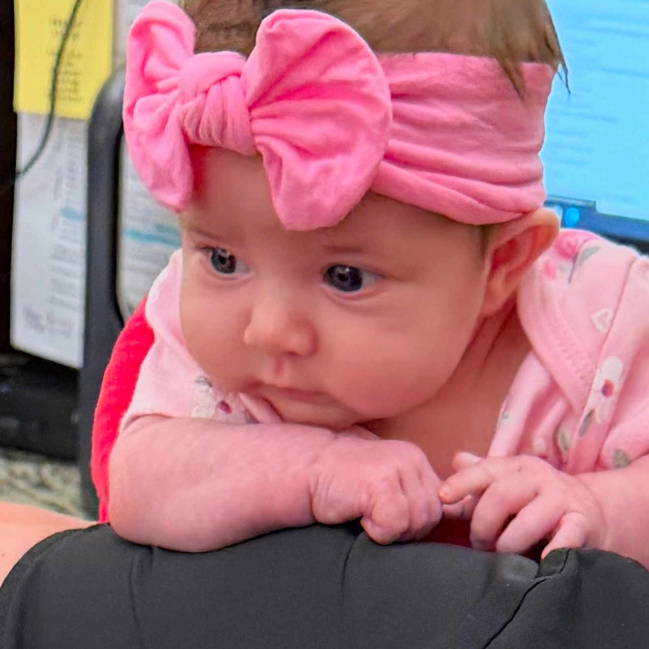 Raylynn is registered to the contest to win money with this photo: baby, pink_bow, headband, infant, cute, indoor, closeup, resting, clothing, hands, face, expression, soft_lighting, curious, child, person, portrait, small_hands, young, adorable