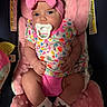 baby, bow, child, clothing, colorful, comfortable, cute, footwear, headband, heart_pattern, indoors, infant, newborn, pacifier, person, pink, plush_seat, portrait, sitting, soft_toys
