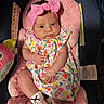 Raylynn is registered to the contest to win money with this photo: adorable, baby, baby_clothing, car_seat, child, chubby_cheeks, closeup, colorful_dress, cushion, cute, headband, hearts, human, indoor, infant, pink_bow, portrait, seat, socks, soft_texture