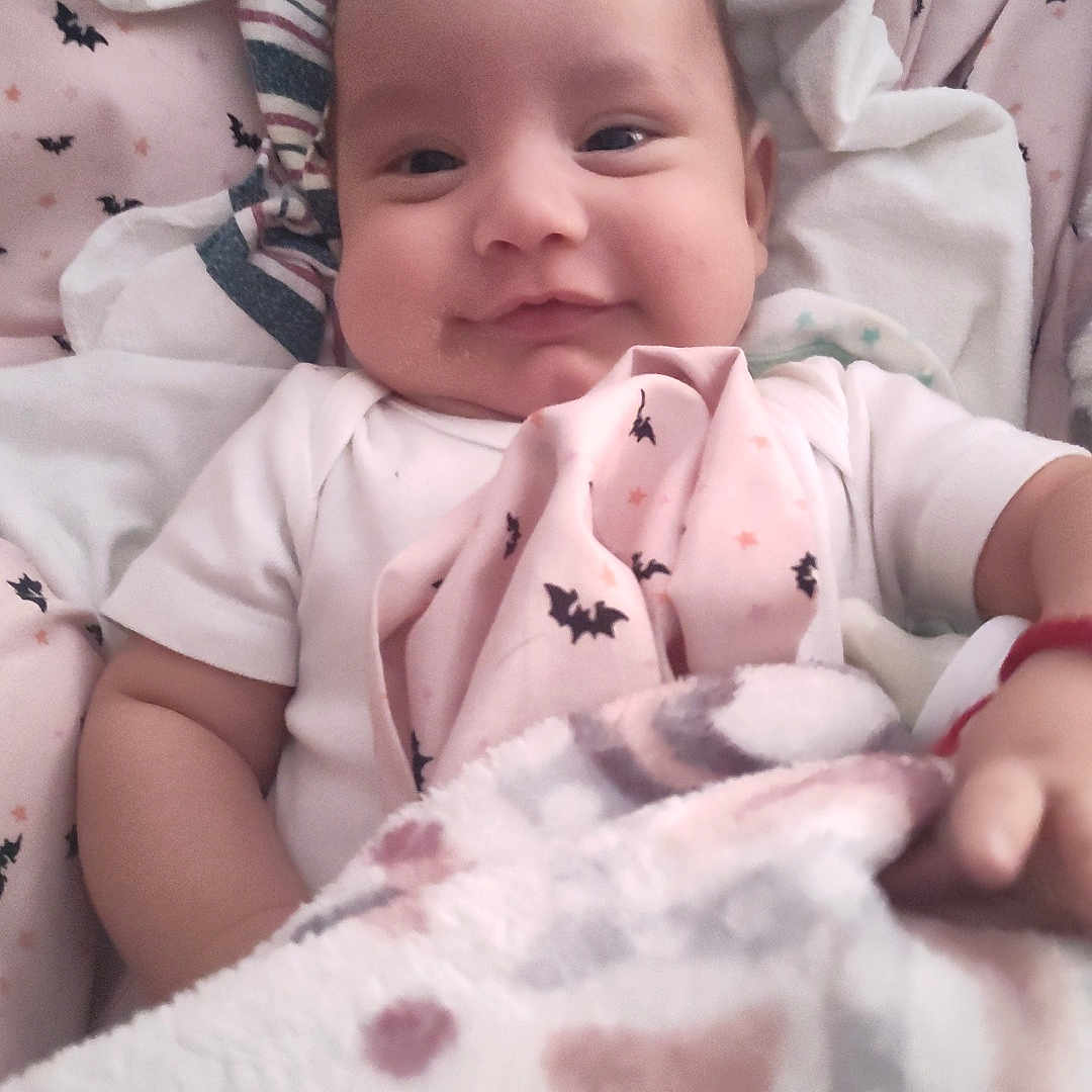 Michael Schmelzer joined the competition — help win amazing prizes! baby, bat, bedding, blanket, child, clothing, comfort, cozy, cute, face, happy, indoors, infant, pattern, portrait, resting, sleepwear, smiling, soft, young