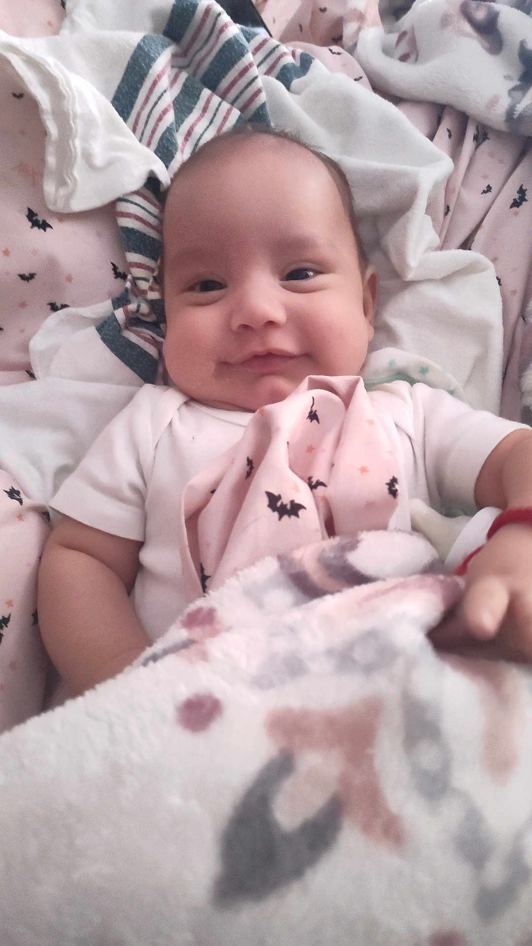Michael Schmelzer joined the competition — help win amazing prizes! baby, infant, smiling, blanket, bedding, cozy, cute, child, face, portrait, soft, comfort, indoors, sleepwear, pattern, bat, clothing, young, happy, resting