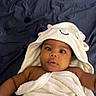 baby, child, towel, hood, cute, infant, face, skin, expression, eyes, mouth, blanket, bed, fabric, sleepy, ears, white, blue, person, portrait