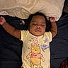 Naela joined the competition — help win amazing prizes! baby, sleeping, onesie, winnie_the_pooh, piglet, bed, pillow, infant, clothing, child, relaxing, cute, peaceful, indoors, person, dark_background, soft_lighting, arms_up, pacifier, resting