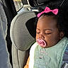 Naela is registered to the contest to win money with this photo: baby, sleeping, car_seat, car, pacifier, pink_bow, curly_hair, child, infant, bib, little_dreamer, portrait, indoors, sunlight, vehicle, seatbelt, rear_seat, peaceful, cute, resting