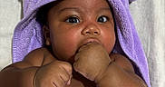 Naela is registered to the contest to win money with this photo: baby, child, towel, purple, face, hand, skin, cute, portrait, infant, eyes, expression, blanket, bed, sleepwear, fingers, soft, warm, indoors, newborn