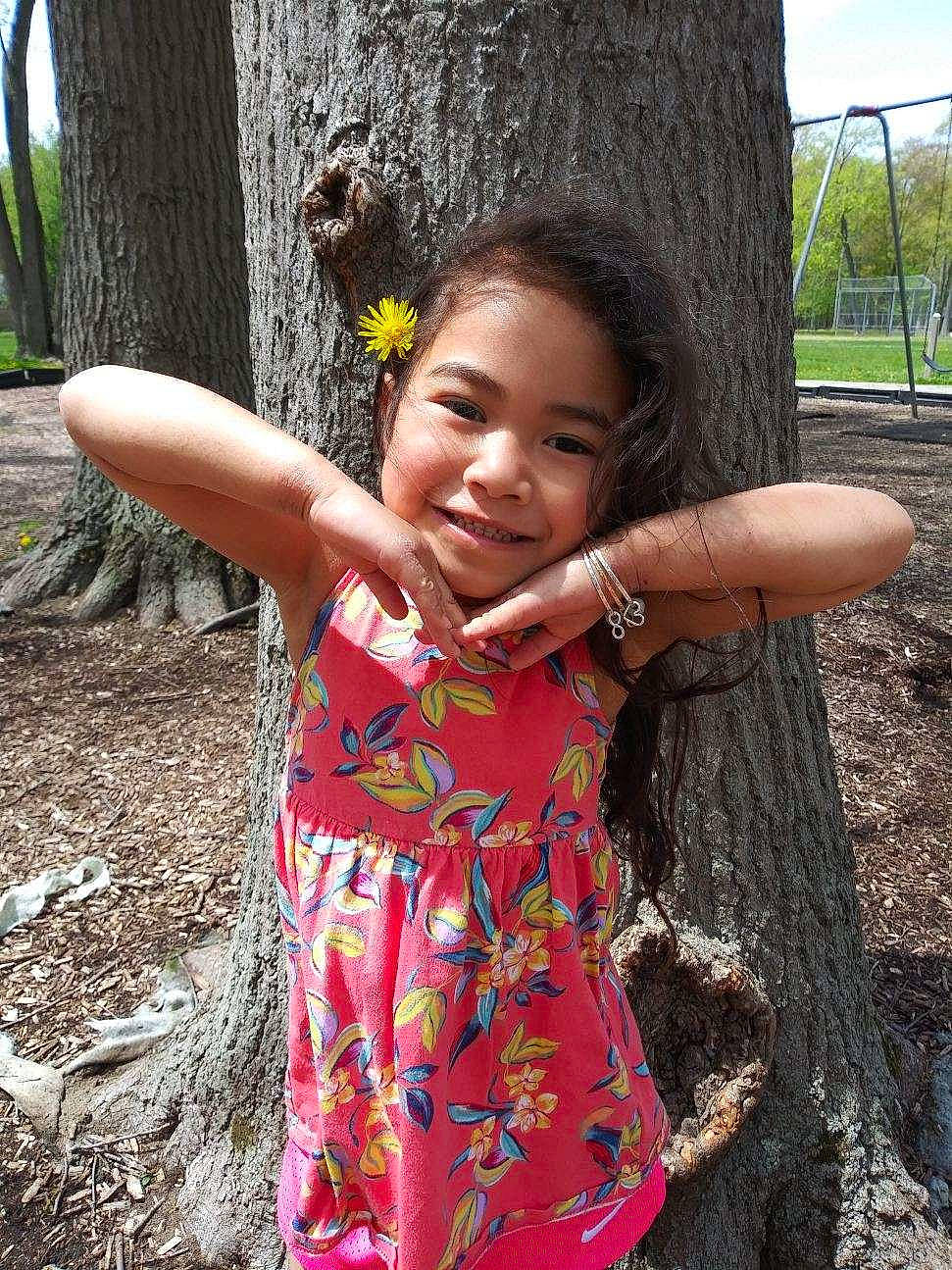 Kiliana is registered to the contest to win money with this photo: botany, branch, dress, eye, facial_expression, gesture, grass, happy, head, human, human_body, joy, leaf, nature, people_in_nature, person, plant, skin, smile, tree