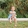 toddler, child, smiling, blue_dress, teddy_bear, bench, outdoor, greenery, grass, happy, cute, sandals, person, nature, daylight, portrait, young_child, sitting, toy, playful