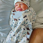 Wyatt is registered to the contest to win money with this photo: baby, sleeping, swaddled, blanket, hat, koala_pattern, infant, bed, bedding, soft, peaceful, cute, newborn, resting, cozy, face, tongue, child, wrapped, indoors