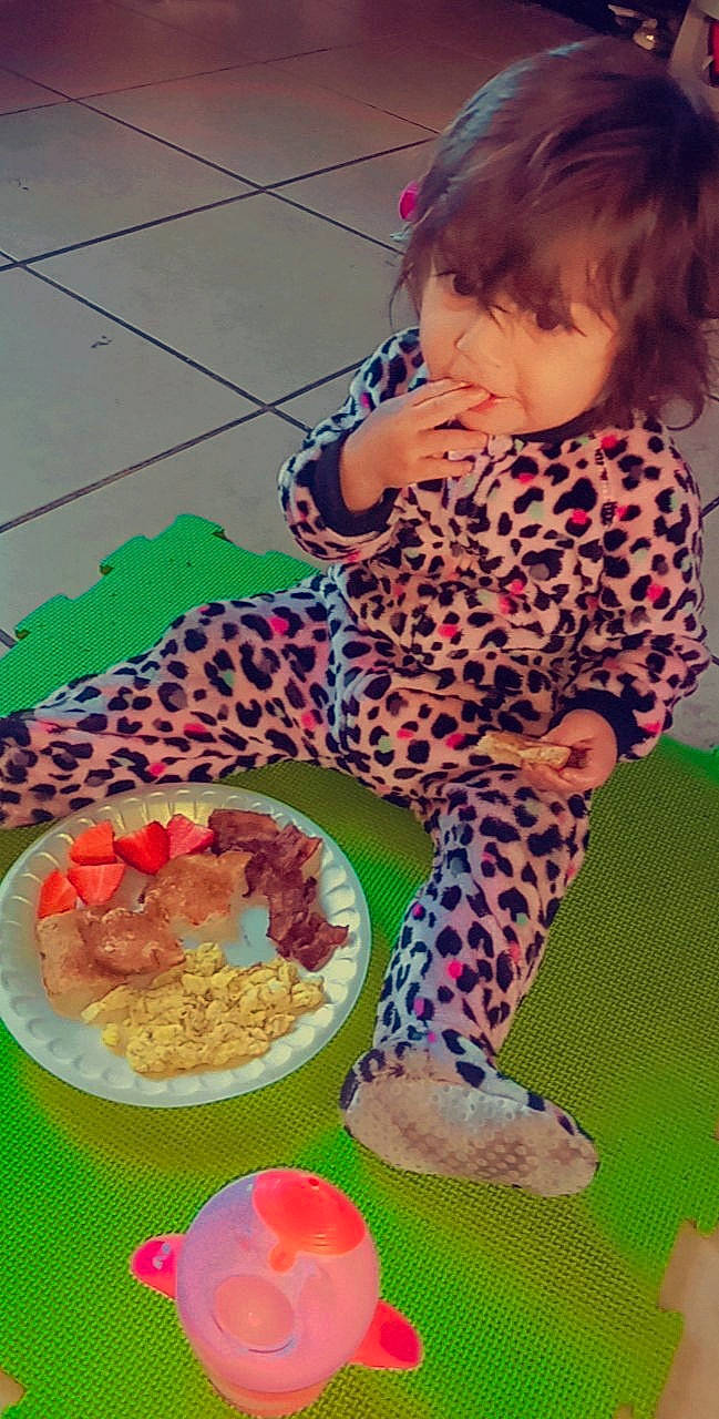 Aurora is registered to the contest to win money with this photo: baby, baby_toddler_clothing, child, comfort_food, flooring, foot, human_leg, ingredient, knee, pattern, person, pink, play, recipe, sitting, sleeve, stuffed_toy, textile, thigh, toddler