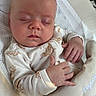 baby, sleeping, onesie, teddy_bear_print, infant, baby_rocker, peaceful, soft_fabric, hand, face, head, newborn, resting, comfort, indoor, closeup, cute, child, portrait, relaxing