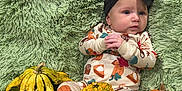 Julie joined the competition — help win amazing prizes! baby, infant, child, pajamas, headband, black_bow, green_rug, gourds, pumpkin, fall_theme, autumn, cute, lying_down, decor, soft_texture, hands_clasped, expression, three_months, indoor, cozy