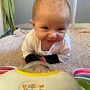 Julie joined the competition — help win amazing prizes! baby, toy, blanket, smile, face, infant, indoor, child, clothing, play, cute, expression, person, young, lying, baby_einstein, colorful, happy, head, eyes